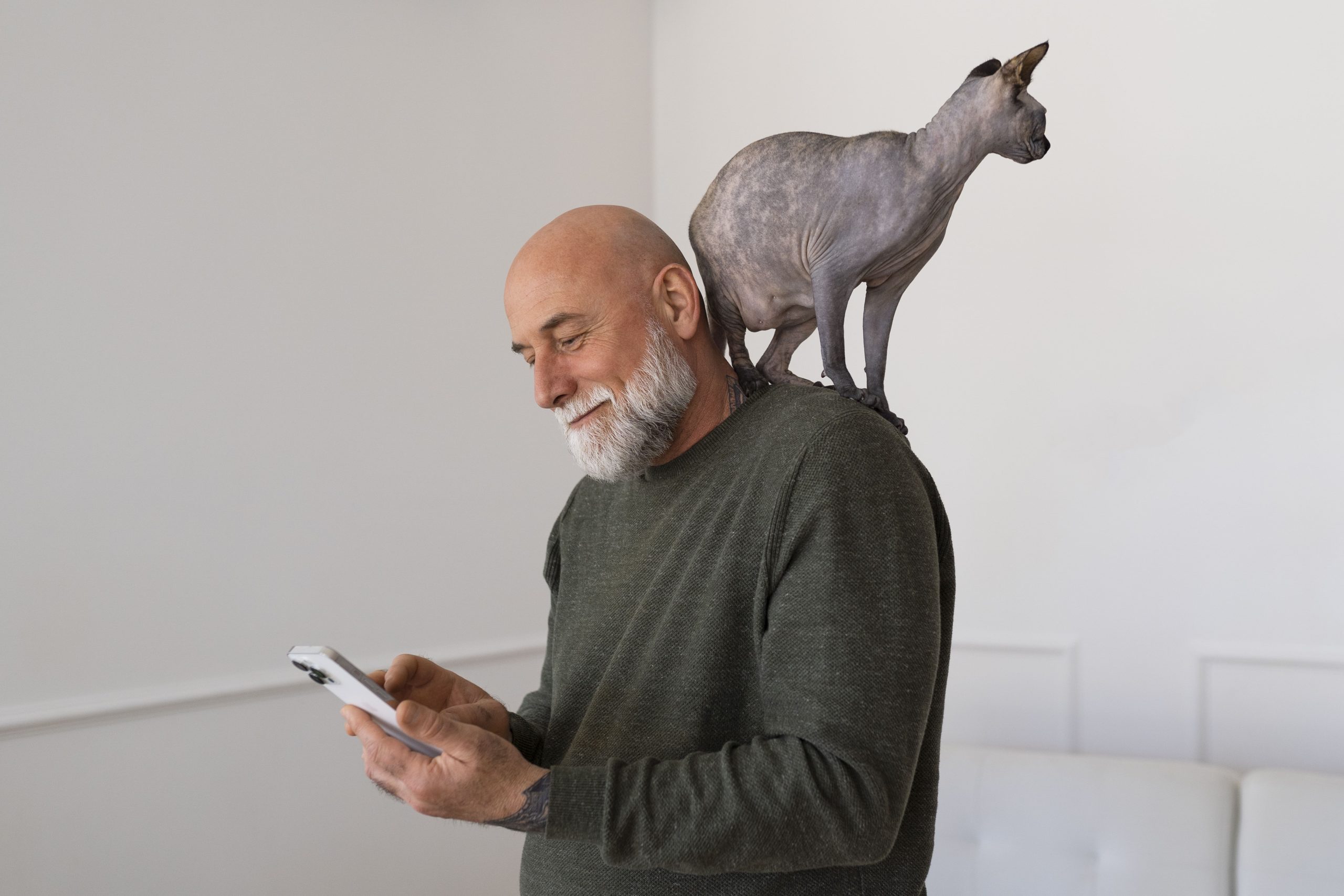 Wag caregiver checks the MileageWise Mileage Tracker App with a cat on his shoulder