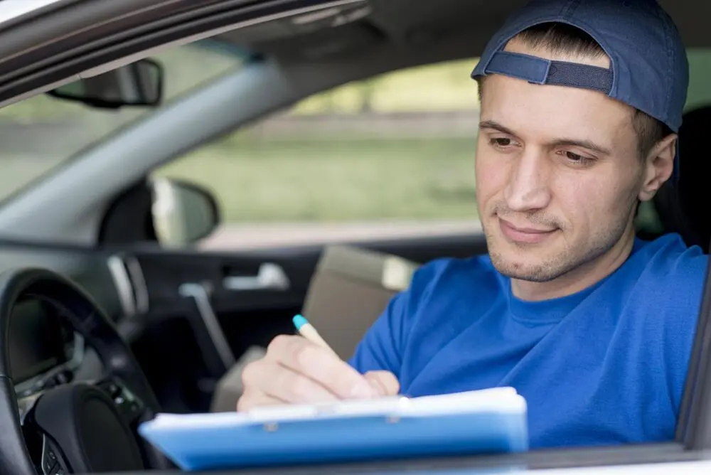 Driver fills out his printable mileage log