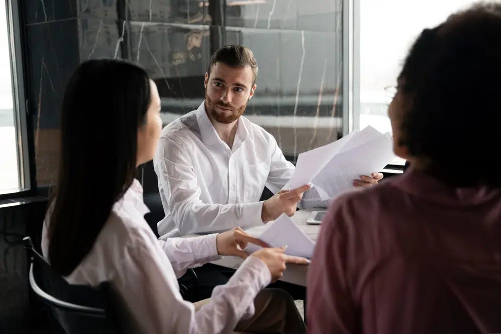 Man introducing the new mileage reimbursement policy to colleagues